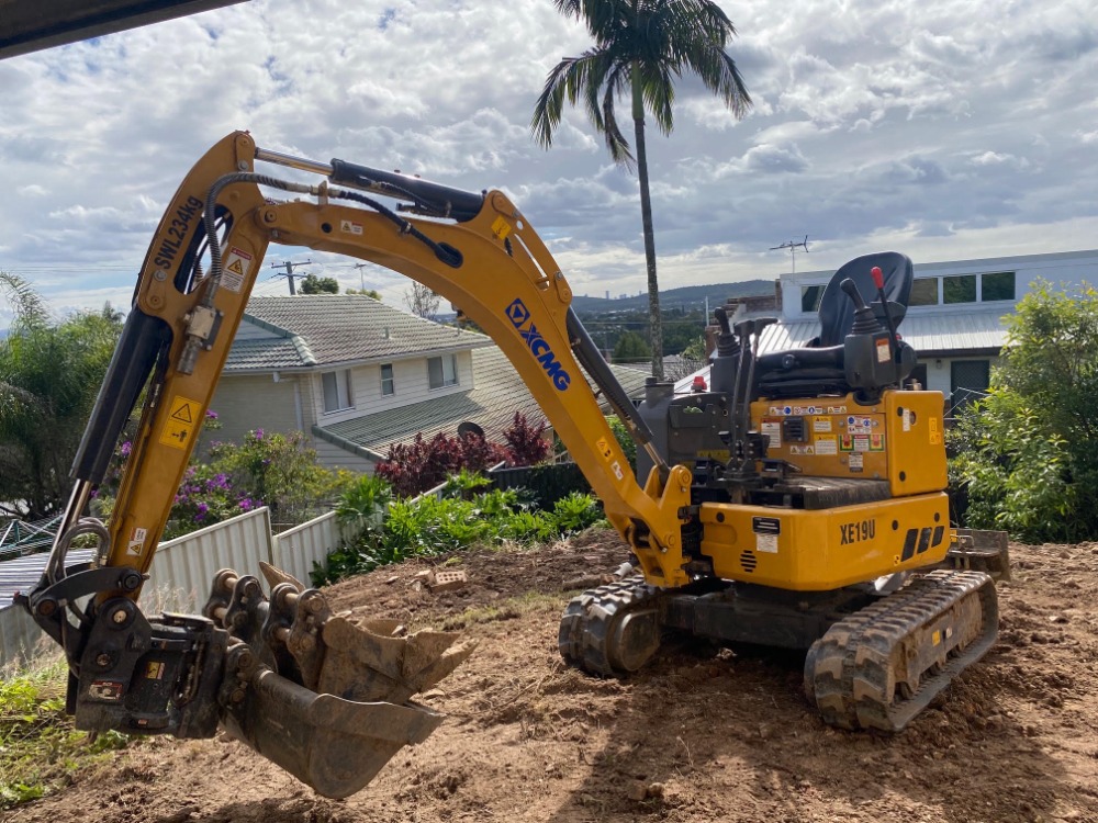 The XCMG 19UE mini excavator positioned at a work site.