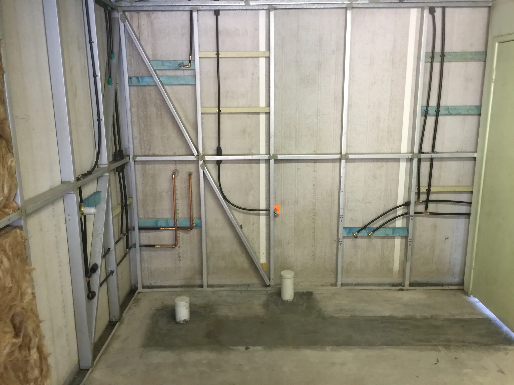 Exposed pipework and fittings installed during a renovation.